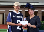 Before the race, Karen Au Yeung, Vice President of LONGINES HK, presents a HK$2,000 prize to the Stables Assistant responsible for Designs On Rome, the best turned out horse in the LONGINES Jockey Club Cup.
