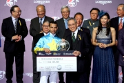 Mr Anthony W K Chow, Deputy Chairman of the HKJC, presents a silver dish and cash prize of HK$200,000 to Joao Moreira, first runner-up of the LONGINES International Jockeys' Championship.