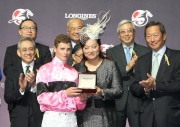 Ms Karen Au Yeung, Vice President of LONGINES Hong Kong, presents a medal to James McDonald, second runner-up of the LONGINES International Jockeys' Championship.