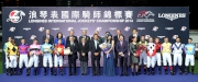 The guests, Stewards and CEO of the HKJC and jockeys take a group photo at the LONGINES International Jockeys' Championship presentation ceremony.