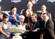 The Hon Jeffrey Lam Kin-fung (right), Member of the Executive Council of the Hong Kong Special Administrative Region, presents a bronze statuette of a horse and jockey to Dr & Mrs Cornel Li Fook Kwan, owner of Able Friend.