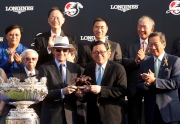 The Hon Jeffrey Lam Kin-fung (right), Member of the Executive Council of the Hong Kong Special Administrative Region, presents a bronze statuette of a horse and jockey to John Moore, trainer of Able Friend.