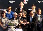 The Hon Jeffrey Lam Kin-fung (right), Member of the Executive Council of the Hong Kong Special Administrative Region, presents a bronze statuette of a horse and jockey to Joao Moreira, jockey of Able Friend.