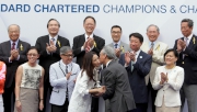 Photo 6, 7<br>
At the Standard Chartered Champions & Chater Cup presentation ceremony, Anthony Chow, Deputy Chairman of the Hong Kong Jockey Club, presents the winning trophy to the owner representative of Helene Super Star.
