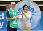 Before the race, May Tan, Chief Executive Officer, Hong Kong, Standard Chartered, presents a HK$5,000 prize and a souvenir to the Stables Assistant responsible for Dominant, the best turned out horse for the Standard Chartered Champions & Chater Cup.