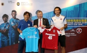 Representatives of Kitchee Lo Kwan-yee (left) and South China Sean Tse (right) present a team jersey to Club CEO Winfried Engelbrecht-Bresges (middle).
