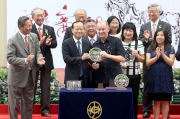 Photos 6, 7<br>
Winning trainer John Moore and jockey Neil Callan receive silver dishes from Deputy Director of the Liaison Office of the Central People's Government in the HKSAR, Yang Jian(left).
