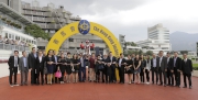 Jockey Nash Rawiller, trainer Dennis Yip, and connections of Secret Weapon celebrate their victory after the race.