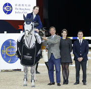 Club Chairman Dr Simon Ip (second left) and Club Steward and President of the Hong Kong Equestrian Federation Michael Lee (first right) present the HKJC Trophy to Martin Fuchs (first left) from Switzerland.