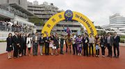 Connections of Invincible Dragon celebrate their victory after the race.
