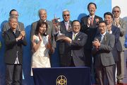 At the Standard Chartered Champions & Chater Cup presentation ceremony, Michael Lee (right), Steward of the Hong Kong Jockey Club, presents the winning trophy to Johnson Chen, the Owner of Werther.